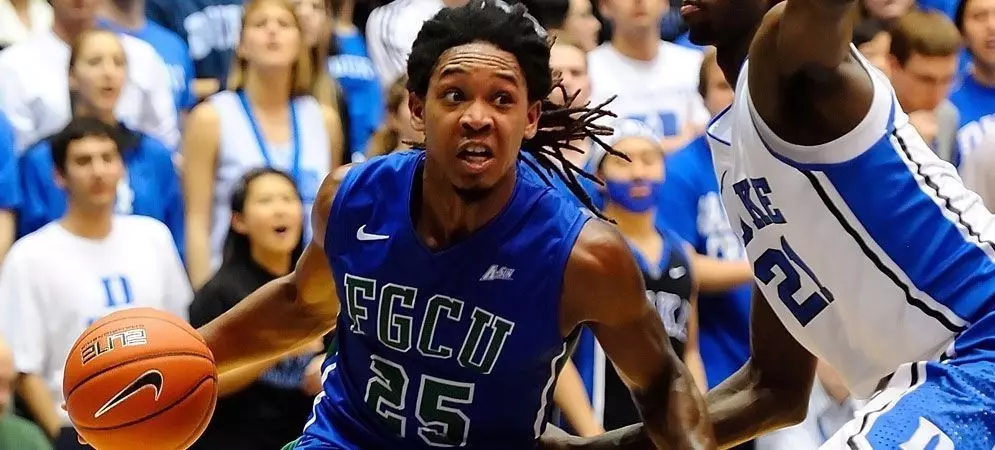 Sherwood Brown driving to the basket past a Duke defender in front of a packed crowd
